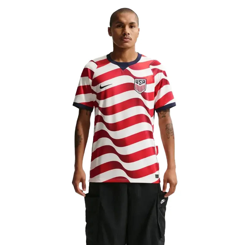 Person wearing a red and white striped soccer jersey with a logo on a white background